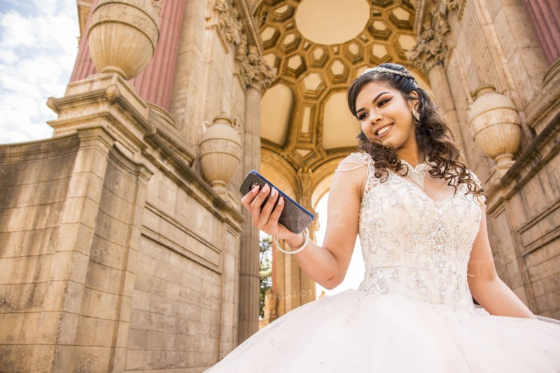 Smiling Hispanic girl texting on cell phone