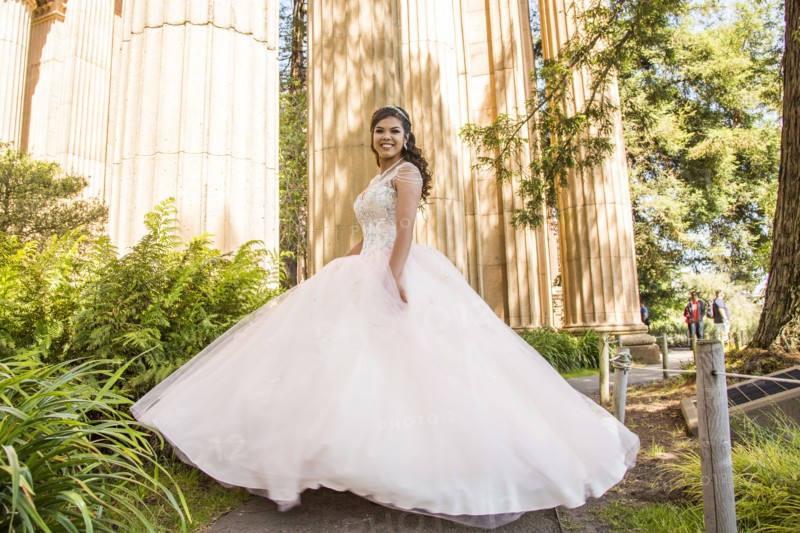 Portrait of smiling Hispanic girl wearing gown