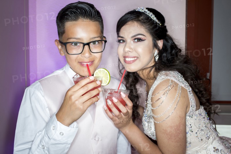 Hispanic boy and girl drinking beverages with straws