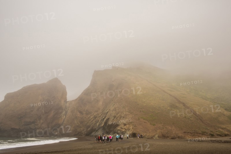 Distant crowd of people standing on beach