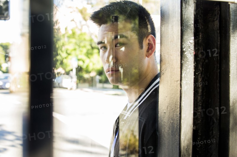 Serious Chinese man behind window