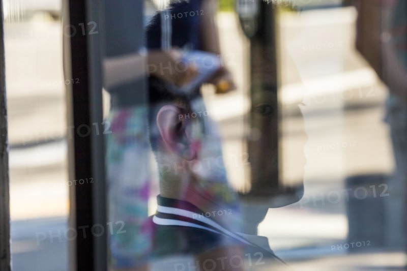 Serious Chinese man behind window