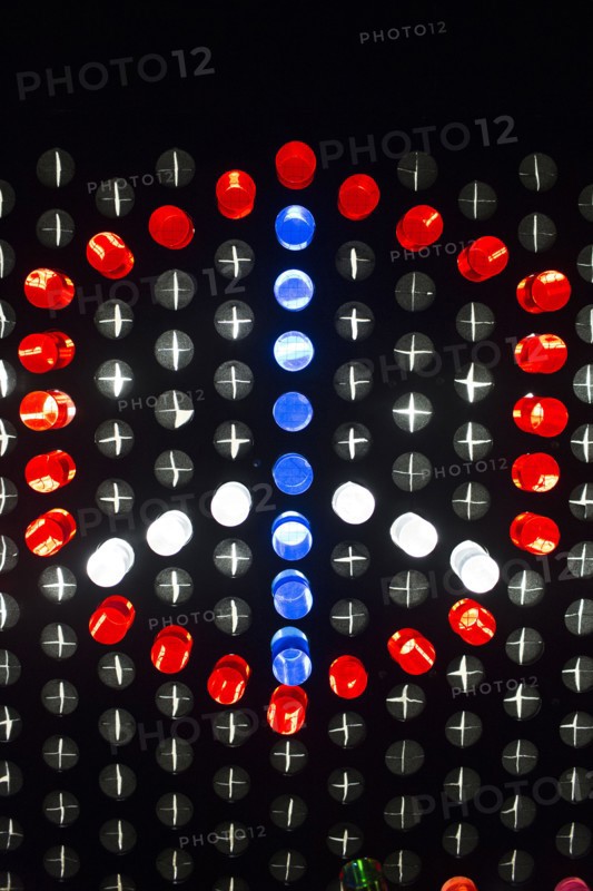Colorful game pieces on puzzle wall forming peace symbol