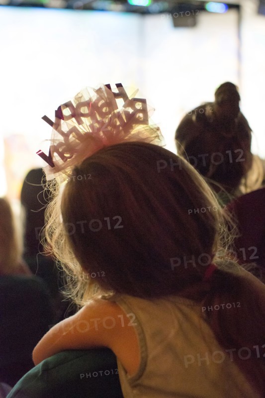 Rear view of Caucasian girl wearing birthday headband