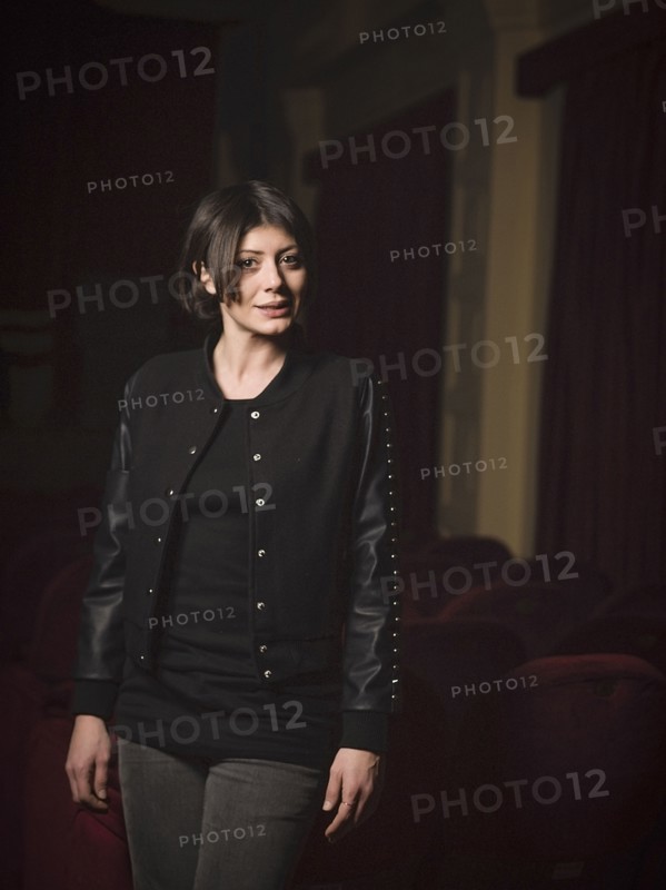 Caucasian woman standing in movie theater