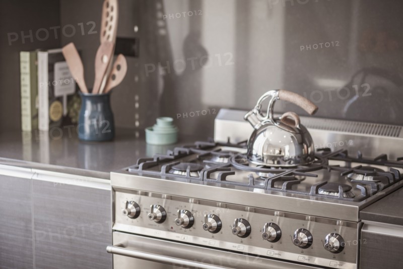 Kettle on stainless steel stove in modern kitchen
