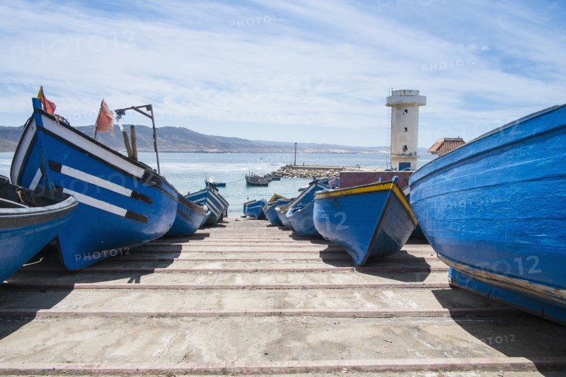 Blue boats docked on boat ramp