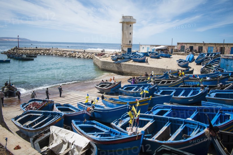 Blue boats docked on boat ramp