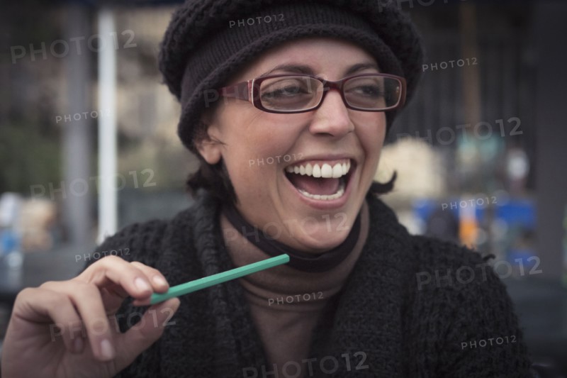 Close up of laughing Caucasian woman holding pencil
