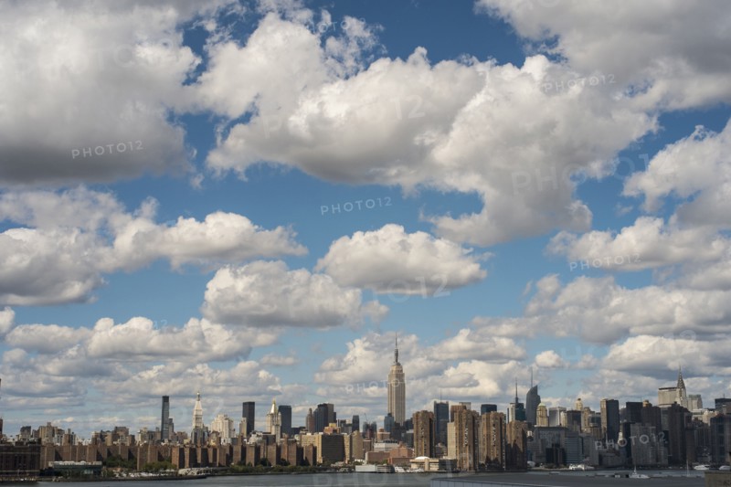 New York City skyline under cloudy blue sky