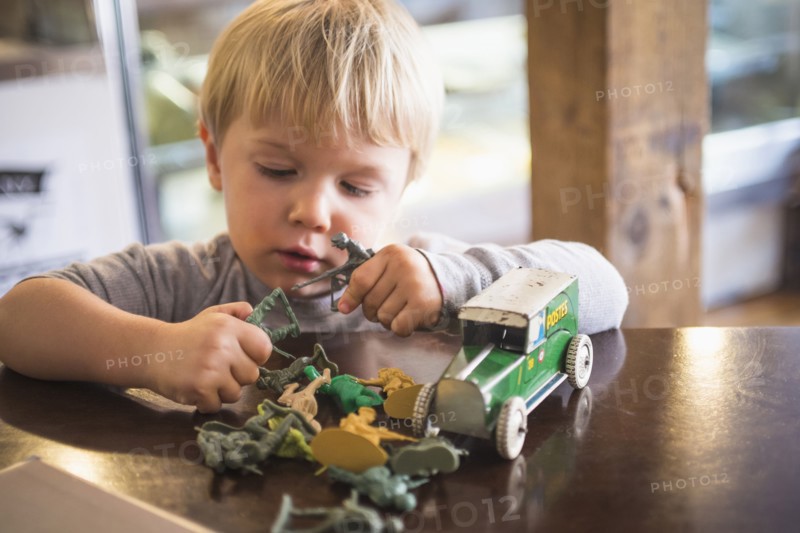 Caucasian boy playing with toys on table