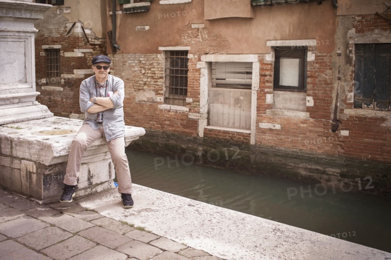 Caucasian tourist standing on canal waterfront