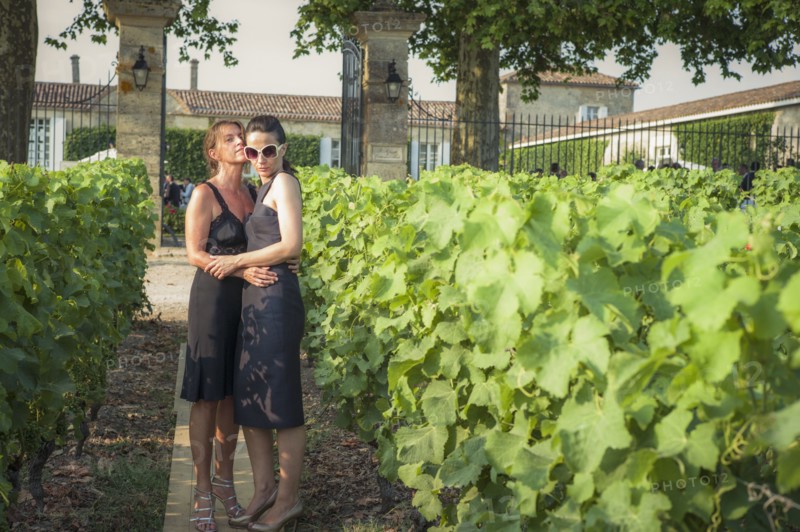 Caucasian lesbian couple hugging in vineyard