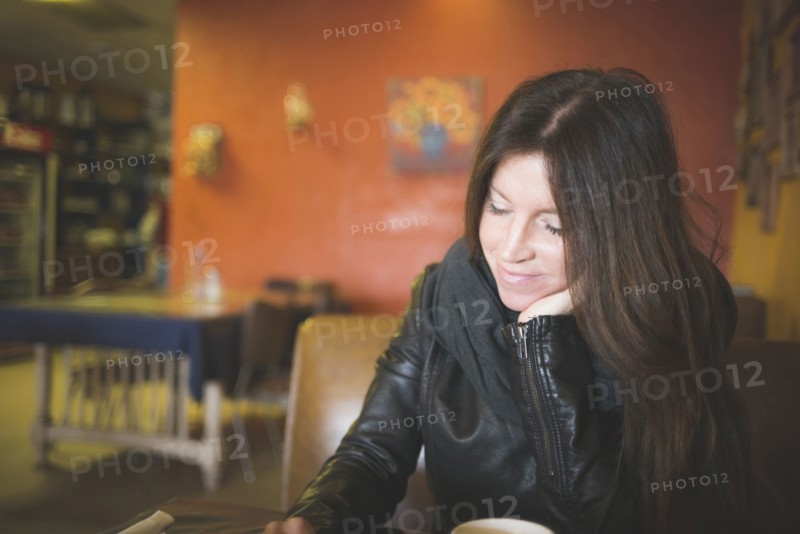 Caucasian woman reading in cafe