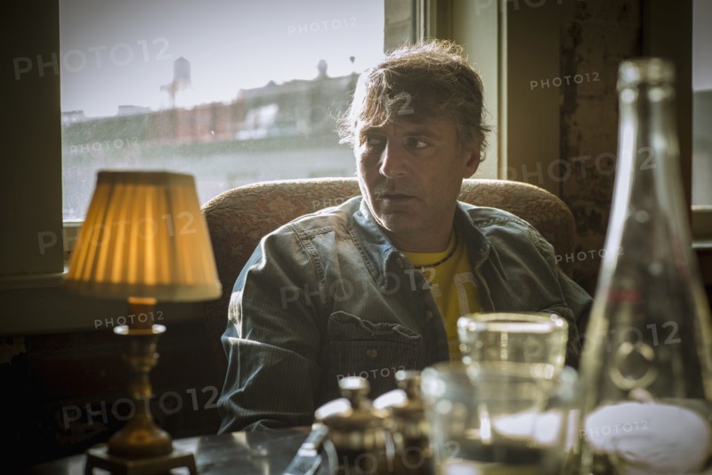 Caucasian man sitting at table near window