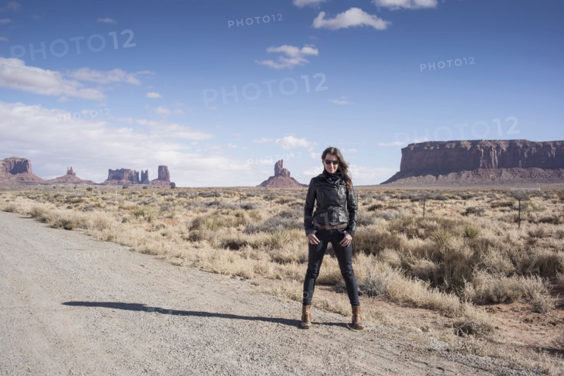 Caucasian woman standing on desert dirt road