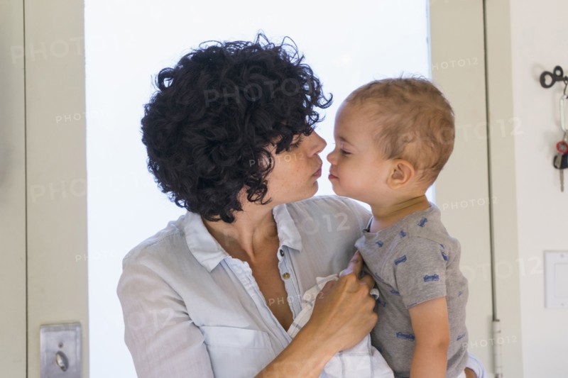 Caucasian mother kissing baby son