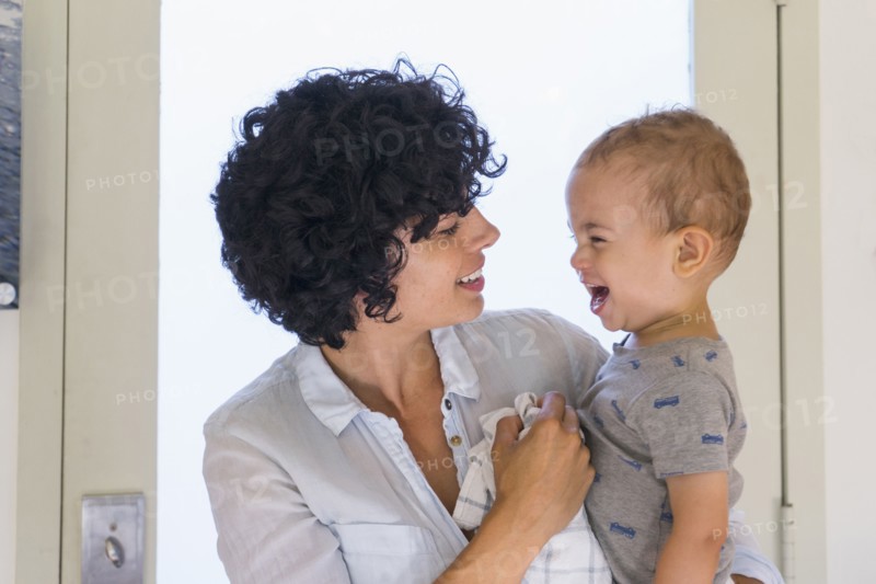 Caucasian mother kissing baby son