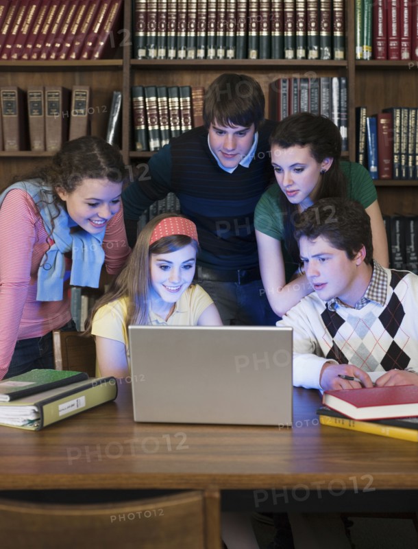 Students using laptop in library
