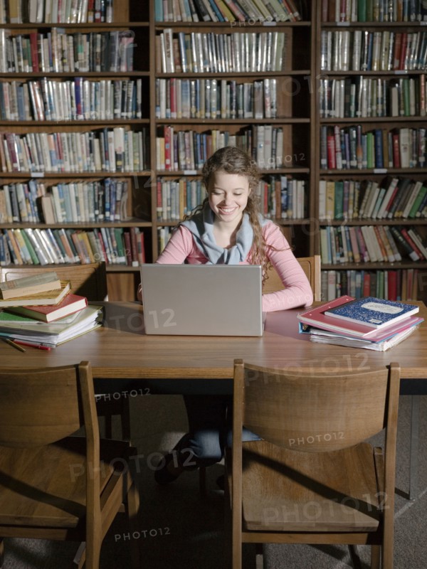 Student using laptop in library