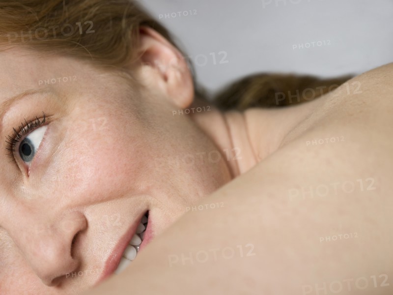 Close up of shoulder and face of nude Caucasian woman