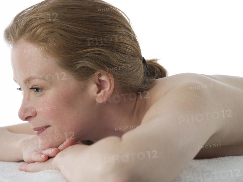 Close up of nude Caucasian woman laying on massage table