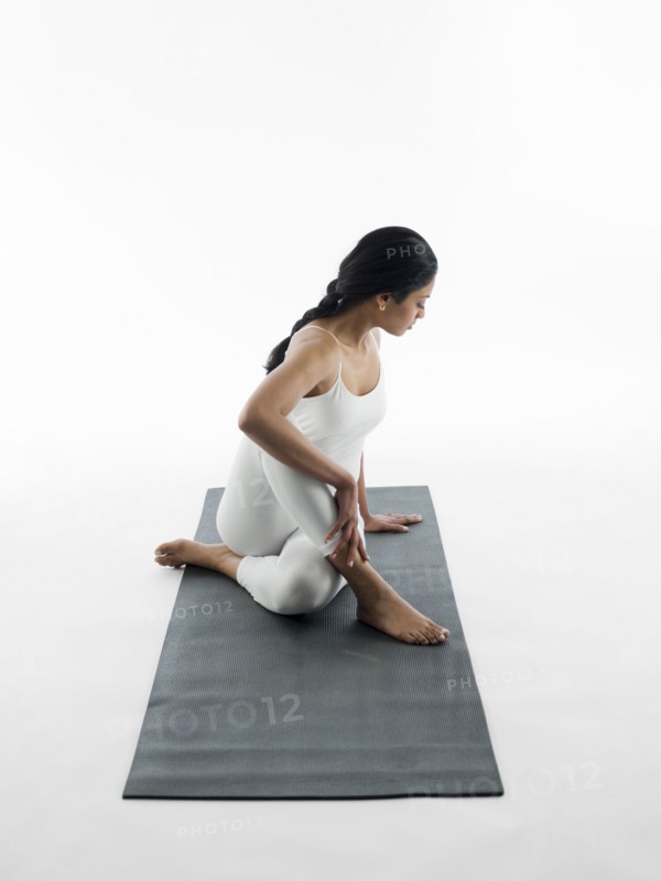 Woman practicing yoga on mat