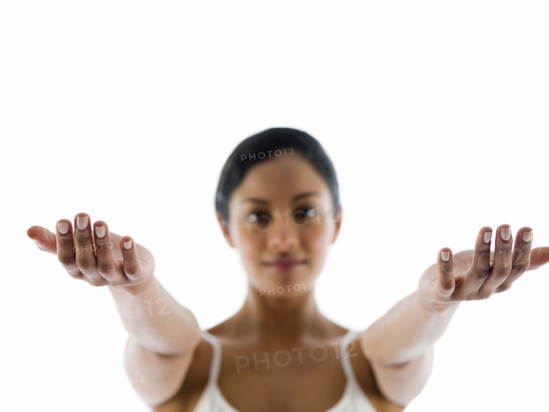 Close up of woman meditating with arms outstretched