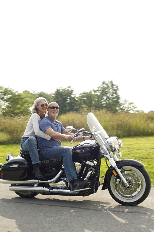 Older couple riding motorcycle
