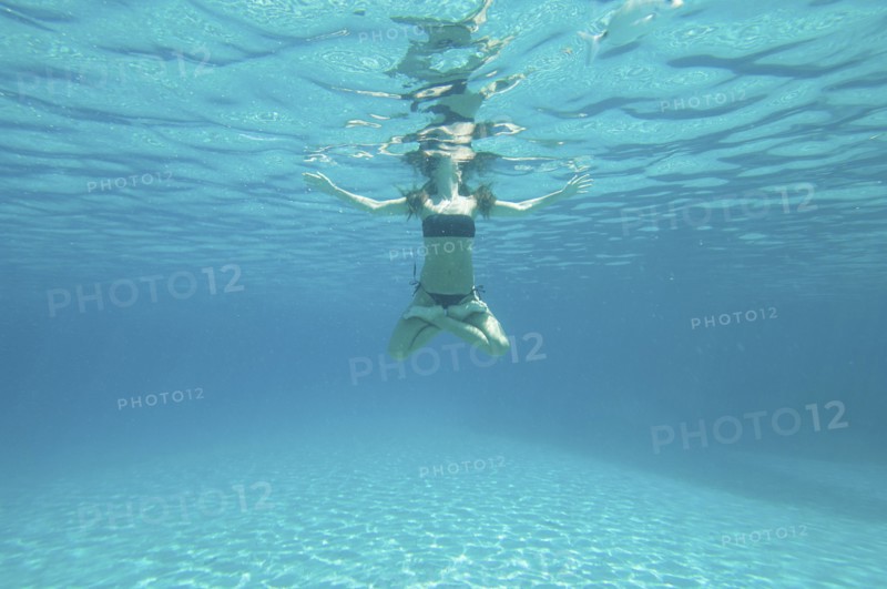 Underwater view of woman swimming in ocean