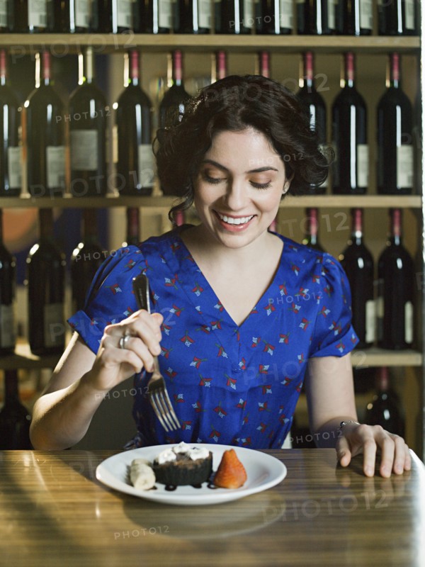 Caucasian woman eating dessert in restaurant