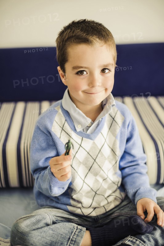 Caucasian boy holding toy soldier