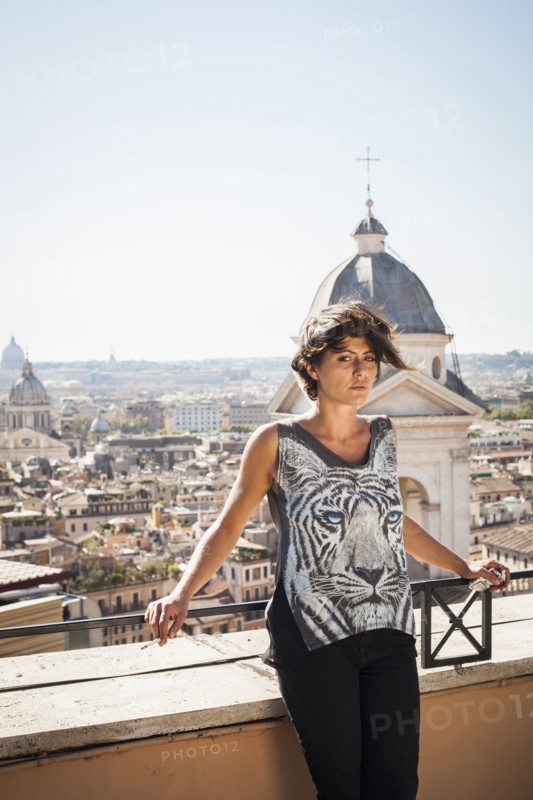 Caucasian woman standing on urban rooftop