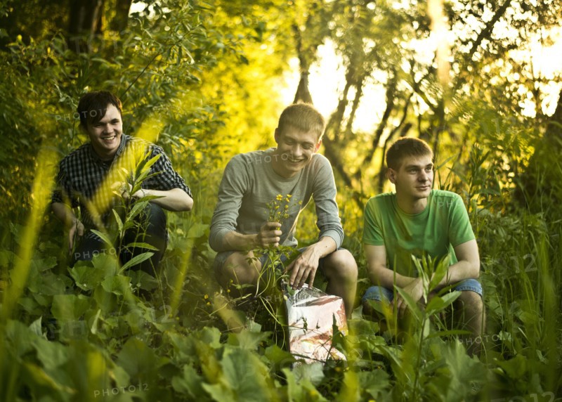 Caucasian men sitting in woods