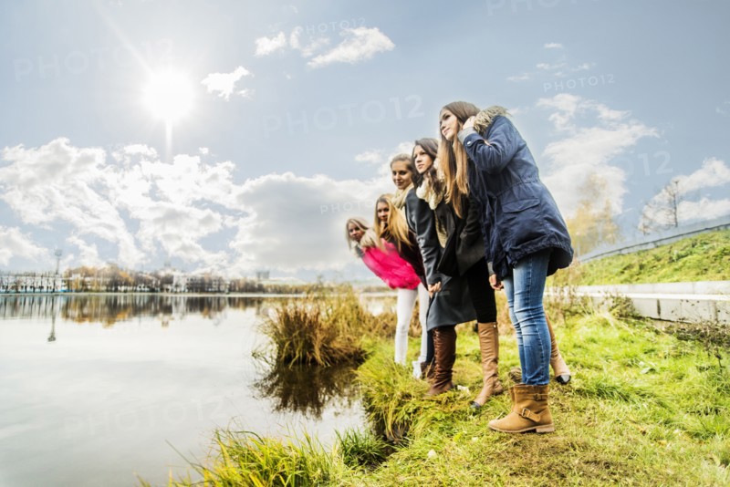 Women overlooking still river
