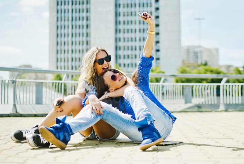Women taking picture on city street