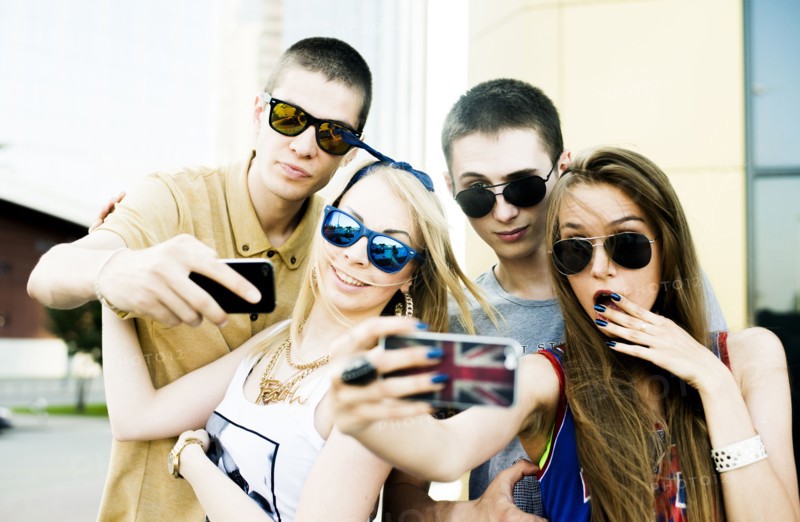 Caucasian couples taking selfie outdoors