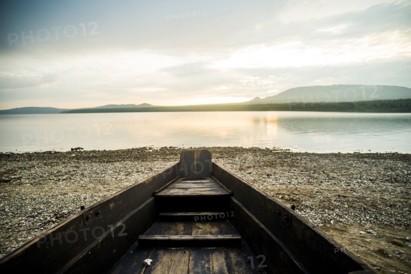 Dilapidated boat at rural lake
