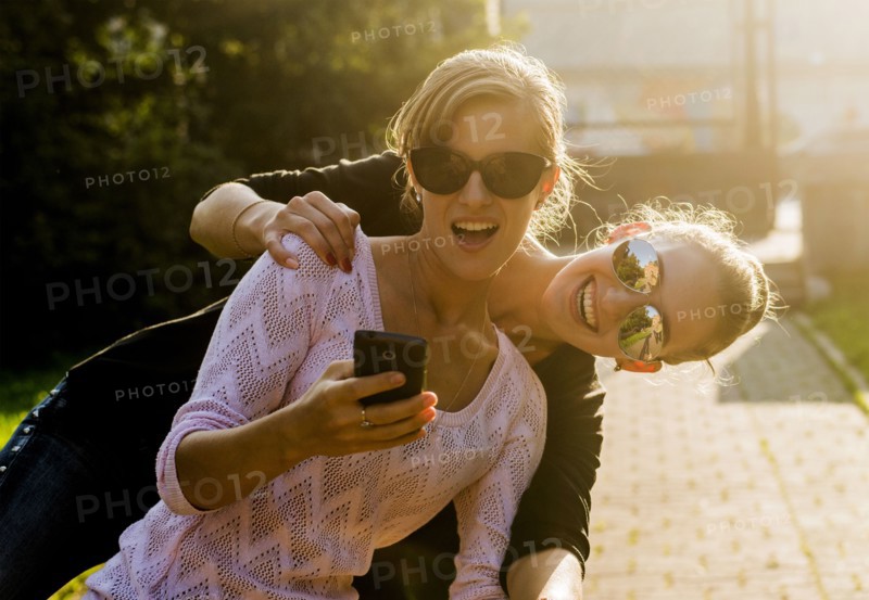 Caucasian women taking cell phone selfie