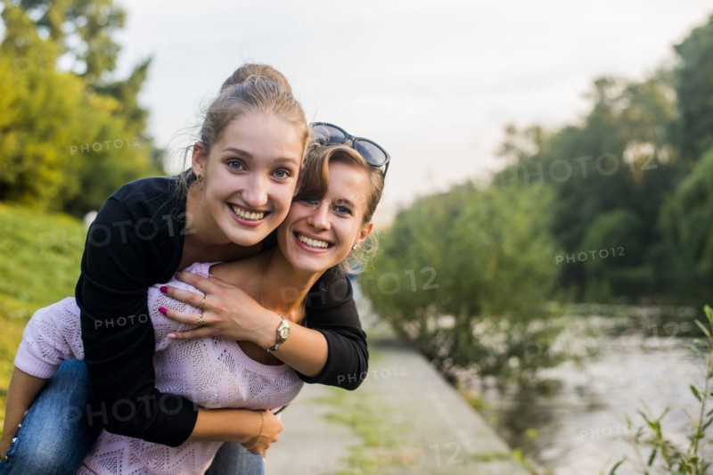 Caucasian women playing near river