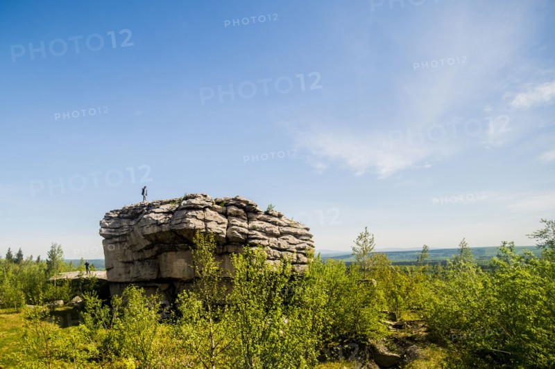 Caucasian climber standing on rock formation