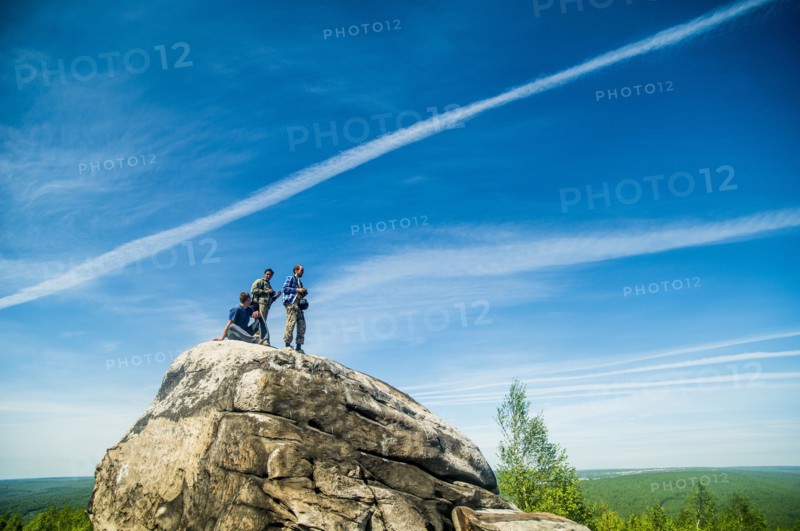Caucasian climbers standing on rock formation