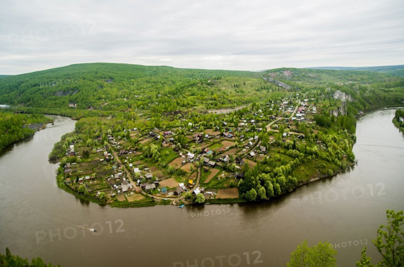 Aerial view of village near bend in river
