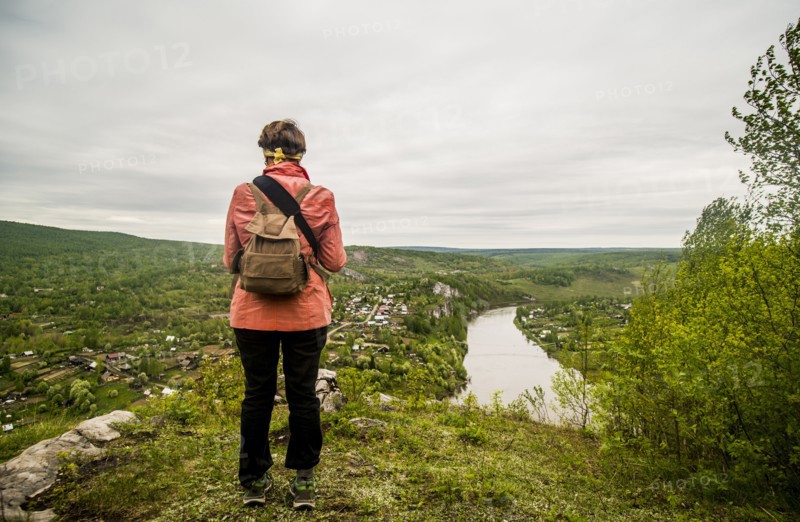 Caucasian hiker admiring scenic view of village