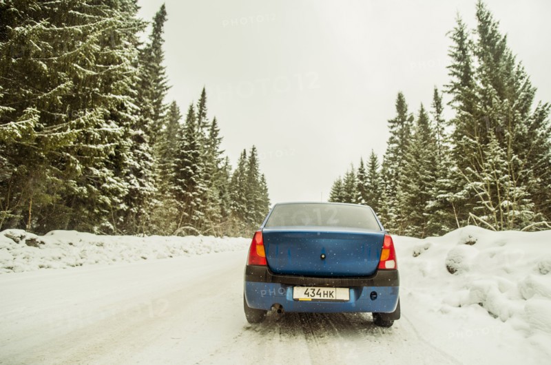 Car driving on snowy remote road