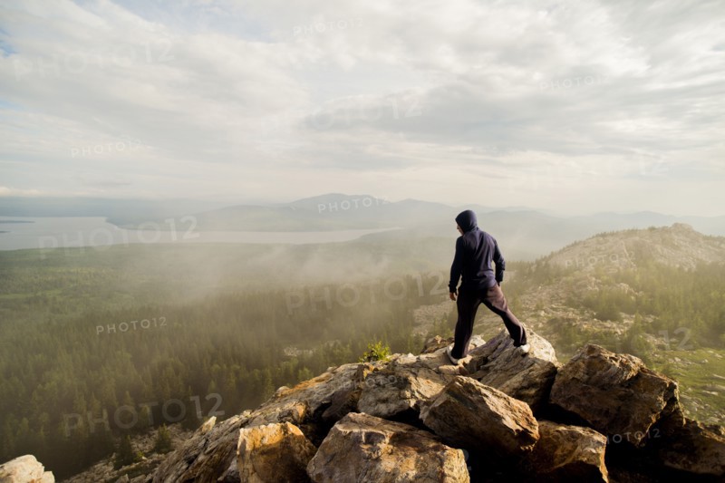 Caucasian hiker standing on rocky hilltop