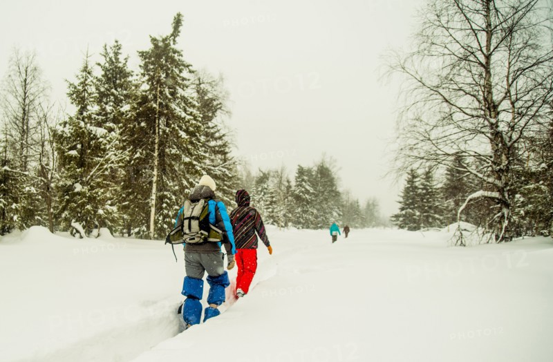 Caucasian hikers walking in deep snow
