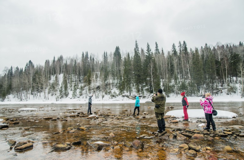 Caucasian hikers walking in rocky remote river