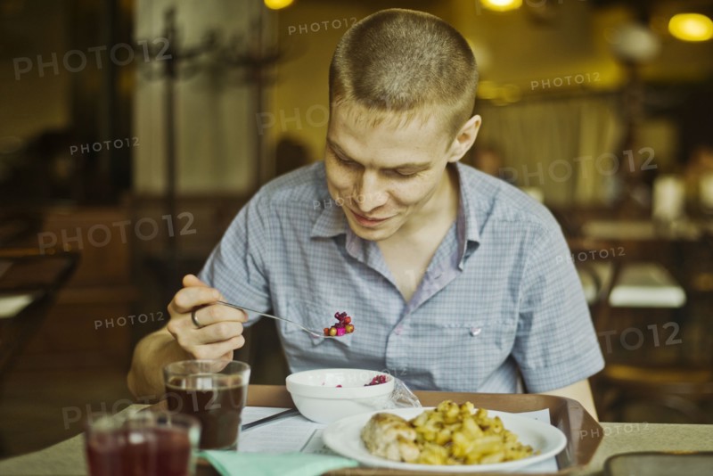 Caucasian man eating lunch at table