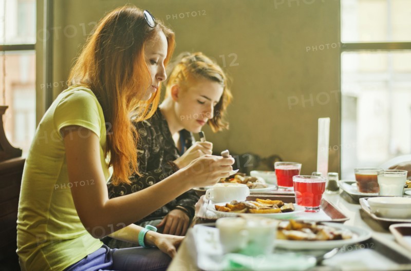 Caucasian women eating in dining room